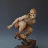 DUDE! ;  Bronze sculpture, edition of 25;19"H x 13"W x 13"D;Image of a male skateboarder, caught up in the thrill of riding the half pipe on the rear wheels, oblivious to the risk and feeling the exhileration of defying physics and reveling in his sense of mastery.